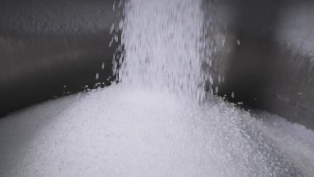 The plastic granules are poured into a large tank. Production of polymer compounds.