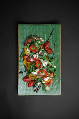 top view of bruschetta or toast bread with arugula, tomatoes, cheese and pepper