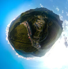 small planet aerial panorama of the Rosa Khutor resort in the Mzymta river valley and the Sanki luge and bobsleigh complex in the Caucasus mountains on a sunny summer day - obrazy, fototapety, plakaty