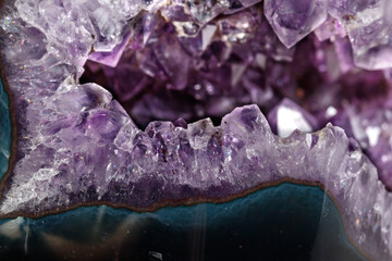 Macro Mineral Stone Amethysts in the rock on a white background