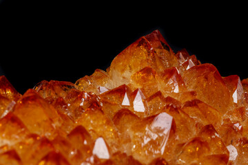 Macro mineral stone Citrine in rock in crystals on a black background