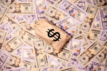 A stag of US paper currency with us dollar sign on US paper currency background.