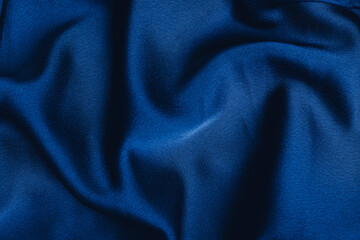 Fototapeta na wymiar Dark blue fabric laid in soft folds