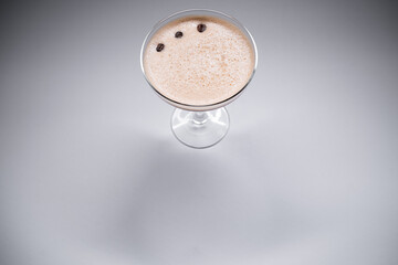 luxury espresso martini cocktail drink in elegant glass on grey background