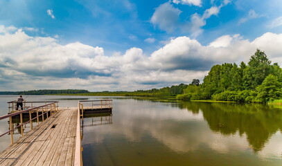 River banks against blue sky with white clouds in summer