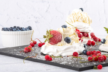 Meringue cake with fresh strawberries and blueberries. Cake Anna Pavlova. Close up.
