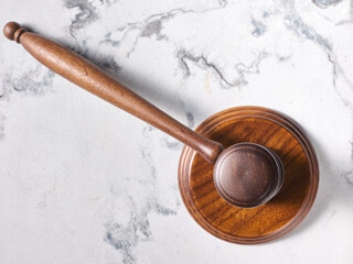 Judge's auction gavel on marble table - top view