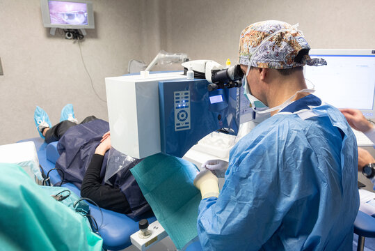 Ophthalmologist Surgeon Performing A Surgery On A Patient