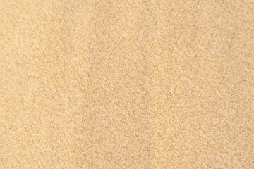 Fototapeta na wymiar Sand texture background. Brown desert pattern on tropical beach.