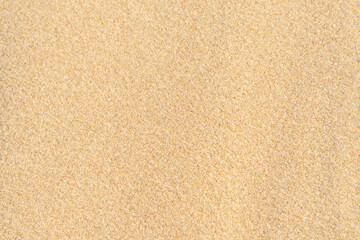 Fototapeta na wymiar Sand texture background. Brown desert pattern on tropical beach.
