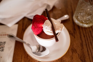 chocolate with strawberry and whipped cream in a teacup
