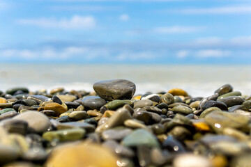 Sea waves blue sky sea pebbles.