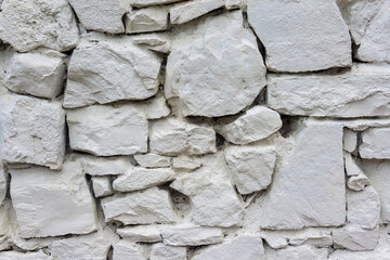 Stone laying of the wall of the house .