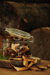 Dried mushrooms in a glass jar on a wooden background. Freeze-dried vegetables. Dried spices healthy food. Spices.