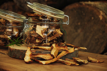 Dried mushrooms in a glass jar on a wooden background. Freeze-dried vegetables. Dried spices healthy food. Spices.