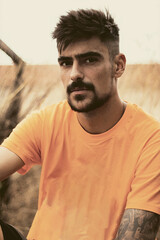 Portrait of a handsome young black-haired man with a beard and mustache