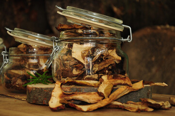 Dried mushrooms in a glass jar on a wooden background. Freeze-dried vegetables. Dried spices healthy food. Spices.