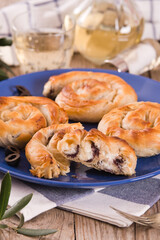 Pastry swirls with cheese and olive filling.