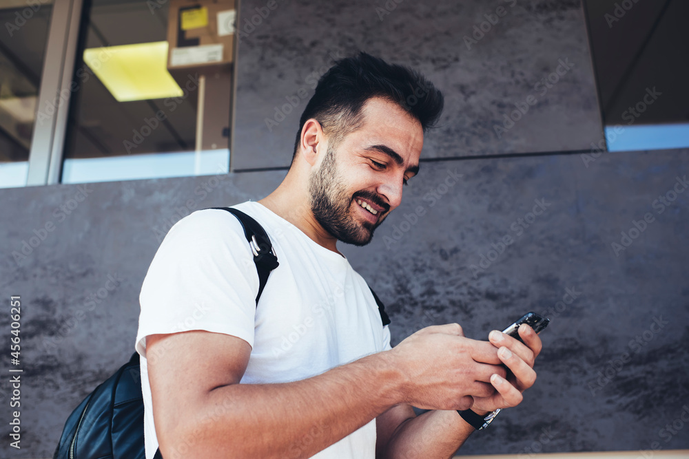 Aufkleber glad tourist in casual clothes writing text message for sending during mobile phoning at city street