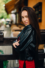 a girl in a red dress looks at the camera with a lion's gaze