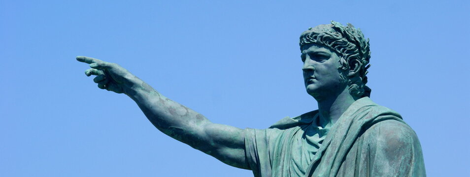 Anzio - Italy, 29 July 2011: statue of Nero created by the sculptor Claudio Valenti inaugurated in 2010 on the waterfront of Anzio, with trees and blue sky in the background. banner, copy space