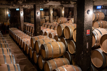 Keeping for years of dry red wine in new oak barrels in caves in Burgundy, made from pinot noir grape