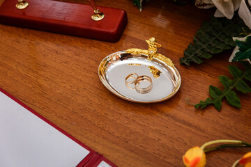 two gold rings on a plate