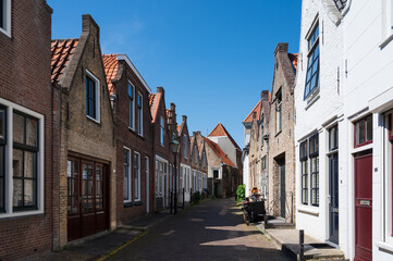 Fototapeta na wymiar Walking in old Dutch town Zierikzee with old small houses and streets