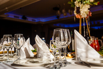 beautiful table setting. glasses, plates on round table in sunlight