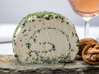 Cheese collection, fresh white soft goat French cheese roll with aromatic herbs and chives