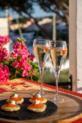 Russian style party with two glasses of white cold champagne, bliny with red caviar and view on...