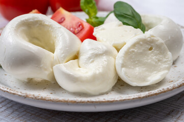 South Italian soft white mozzarella cheese made from buffalo cows milk served with ripe tomatoes and fresh green basil herb