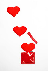 
Red blank condom packed and red heart shape. Empty space for text, mock-up.  Safe sex concept.