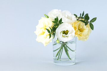 Beautiful modern bouquet of eustoma in glass vase