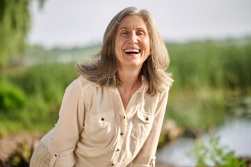 Happy smiling woman outdoors on fine afternoon