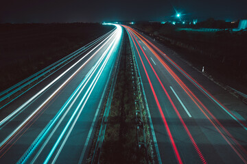 Highway by night with light trails on the road