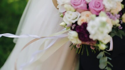 The ribbons on the bouquet of flowers are moving in the wind. Cool shots close up in slow motion