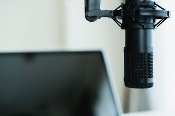 Home sound recording studio and equipment including professional condenser microphone.