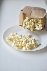 A bag of popcorn open on a plate in the kitchen