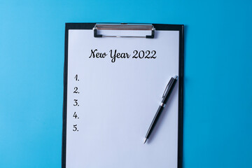 New year 2022 written in a paper on clipboard - business concept. 