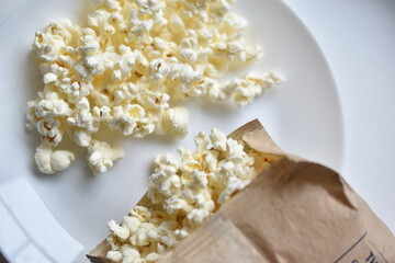 A bag of popcorn open on a plate in the kitchen