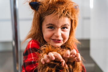Close up of a small boy dressed as werewolf gesturing while scaring the camera during Halloween...
