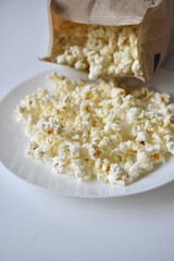 A bag of popcorn open on a plate in the kitchen