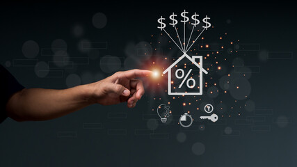 The man's hand pointing at a home icon on the versual screen. The concept of installment and reduction of Home Loan, Interest Calculation, Taxation, saving, and planning.
