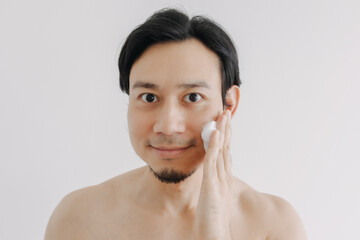 Shirtless Asian man show off his face and skin for skincare product.