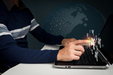 The Laptop computer device and Wireless technology concept. The man's hand typing on computer keyboard while working from home or using the internet for online shopping and social network.