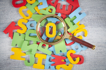 Magnifying glass with a colorful letters.