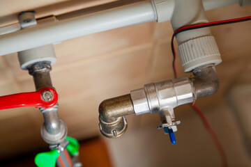 Two taps on plastic water pipes. View from above