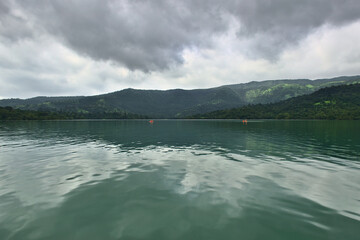 Stunning panoramic landscape view of beautiful Koyna dam backwaters on a cloudy day with kayakers...