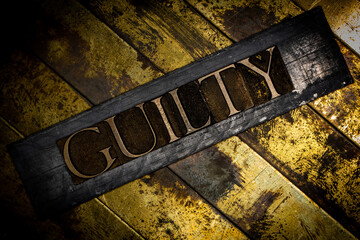 Guilty text on vintage textured copper and gold background